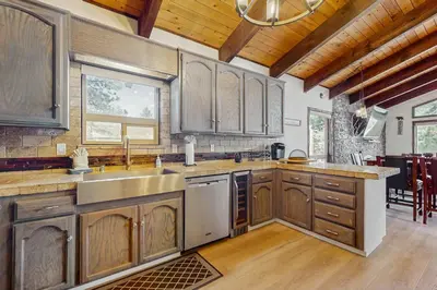 a kitchen with wooden cabinets and a stainless steel sink at The Regan Beach Vista in South Lake Tahoe
