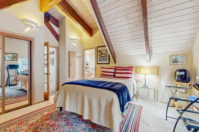 a bedroom with a bed with red pillows on it at Dog-Friendly Retreat with Lake Views in Kings Beach in Kings Beach