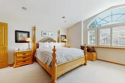 a bedroom with a bed and a large window at Waterfront Bliss in South Lake Tahoe