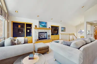 a living room with two couches and a fireplace at Waterfront Bliss in South Lake Tahoe