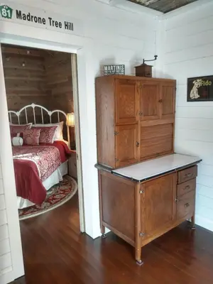 a bedroom with a bed and a wooden dresser at Meadow Creek Cabin in Camino