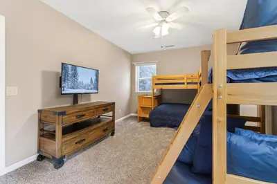 a bedroom with a bunk bed and a tv at The Trailhead Hot Tub, Hikes & Night Skies in Shaver Lake