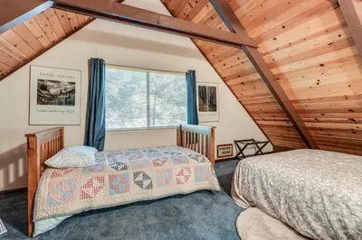 a bedroom with two beds and a large window at 4 Mi to State Park Quiet Escape with Deck in Arnold in Arnold