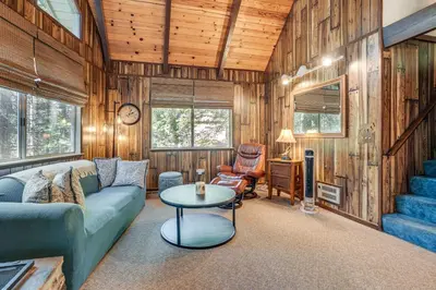 a living room with a couch and a table at 4 Mi to State Park Quiet Escape with Deck in Arnold in Arnold