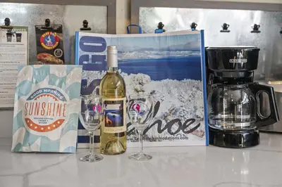 a bottle of wine and two glasses on a table at HCH0648 - Larchwood Lodge home in South Lake Tahoe