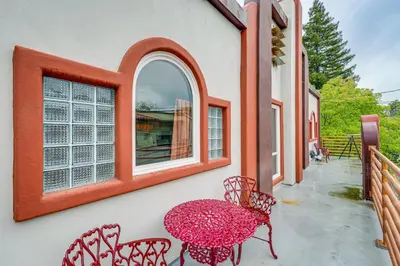 a patio with a table and chairs and a window at Easily Explore Fair Oaks Village! Unique Condo in Fair Oaks