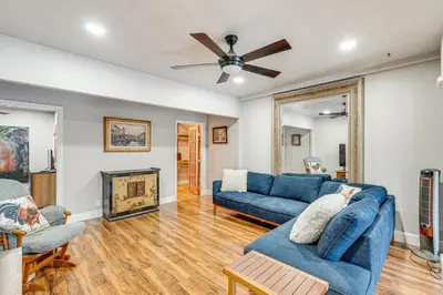 a living room with two blue couches and a fireplace at Easily Explore Fair Oaks Village! Unique Condo in Fair Oaks