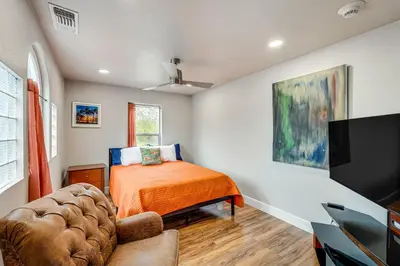 a bedroom with a bed and a flat screen tv at Easily Explore Fair Oaks Village! Unique Condo in Fair Oaks