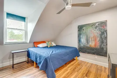 a bedroom with a bed and a painting on the wall at Easily Explore Fair Oaks Village! Unique Condo in Fair Oaks