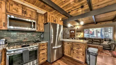 a kitchen with wooden cabinets and a stainless steel refrigerator at COH0809 - Brule Haven home in South Lake Tahoe