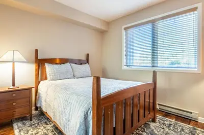 a bedroom with a bed and a window at Mammoth Green #220 - Nearly Ski-In Ski-Out 3 Bedroom 2 Bath, Sleeps 8 in Mammoth Lakes