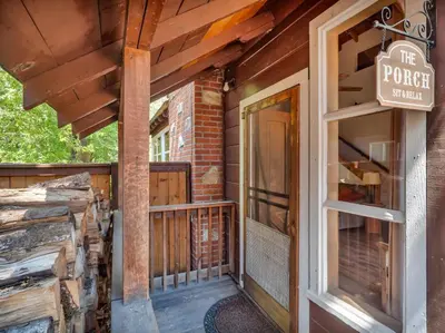 a porch of a house with a door and a sign at Tahoe Classic Cabin Near the Beach in South Lake Tahoe