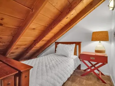 a bedroom with a bed and a desk with a lamp at Tahoe Classic Cabin Near the Beach in South Lake Tahoe