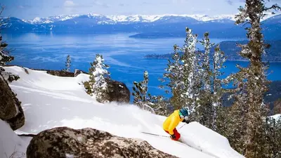 a person is skiing down a snow covered slope at Quaking Aspen Condo in Stateline