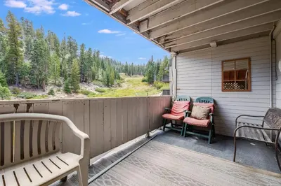 a porch with two chairs and a bench at Quaking Aspen Condo in Stateline