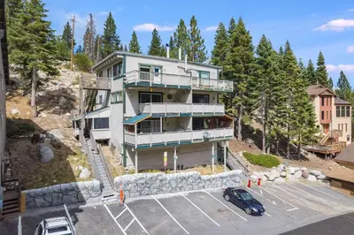 an apartment building on a hill with a parking lot at Quaking Aspen Condo in Stateline