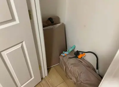 a small refrigerator in a corner of a room at Huth Street Haven in Lake Isabella