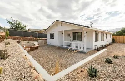 a small white house with a yard at Huth Street Haven in Lake Isabella