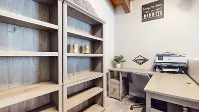 an office with wooden shelves and a desk with a computer at Chateau Blanc #2 condo in Mammoth Lakes