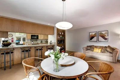 a kitchen and living room with a table and chairs at Spacious Riverfront home in South Lake Tahoe