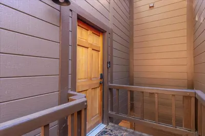 a hallway with a wooden door in a house at Indian Hills 6021 townhouse in Truckee