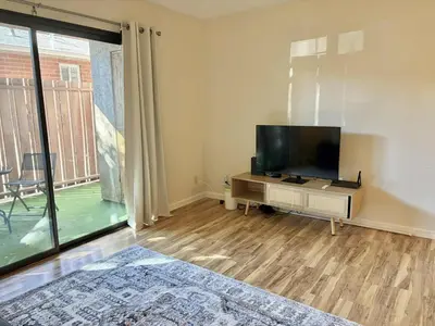 a living room with a flat screen tv and a large window at Near Lake, Golf and Tennis - Reno Condo in Reno