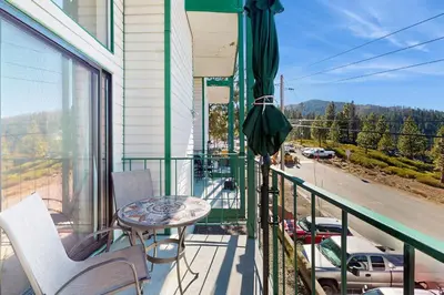 a balcony with a table and chairs and a view of a street at Lakeview Landing in Stateline
