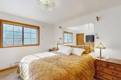 a bedroom with a large bed and a large mirror at Serene Road Lodge in Soda Springs