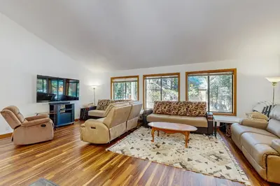 a living room with two couches and a table at Serene Road Lodge in Soda Springs