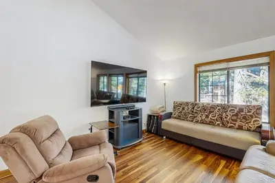 a living room with two chairs and a couch at Serene Road Lodge in Soda Springs