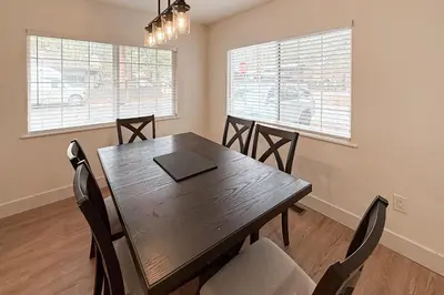 a dining room with a wooden table and chairs at Sierra Pines Retreat Tahoe in South Lake Tahoe