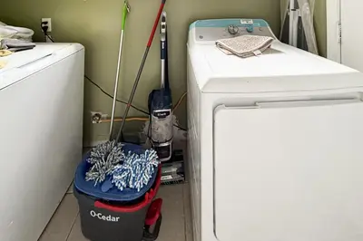 a small refrigerator in a kitchen next to a washing machine at Sierra Pines Retreat Tahoe in South Lake Tahoe