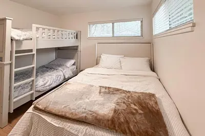 a bedroom with two beds and a bunk bed at Sierra Pines Retreat Tahoe in South Lake Tahoe
