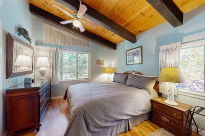 a bedroom with a bed and a wooden ceiling at Chateau Sans Nom 38 in Mammoth Lakes