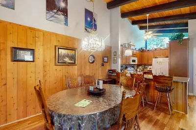 a kitchen and dining room with a table and chairs at Chateau Sans Nom 38 in Mammoth Lakes