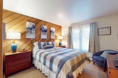 a bedroom with a bed and a desk and a window at Snowcreek 51 in Mammoth Lakes