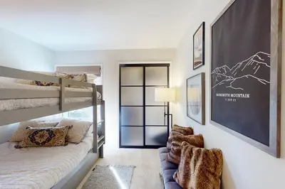 a bedroom with bunk beds and a couch at Sierra Megeve 31 in Mammoth Lakes