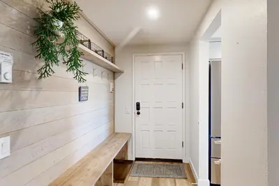 a hallway with a white door and a plant at Sierra Megeve 31 in Mammoth Lakes