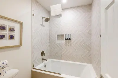 a bathroom with a shower with a tub and a toilet at Sierra Megeve 31 in Mammoth Lakes