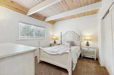 a white bedroom with a white bed and a window at Meyers Tahoe Escape in South Lake Tahoe