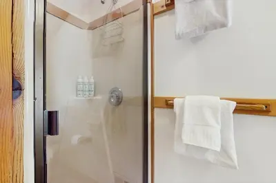 a bathroom with a shower with white towels at Bear Creek Pond Chalet in Alpine Meadows