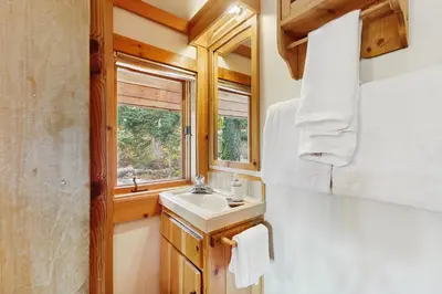 a bathroom with a sink and a window at Bear Creek Pond Chalet in Alpine Meadows
