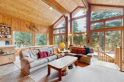 a living room with a couch and a table at Bear Creek Pond Chalet in Alpine Meadows