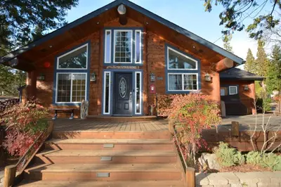 a house with a wooden walkway leading to the front door at Owens Den- Lake AreaFree Night Special in Bass Lake
