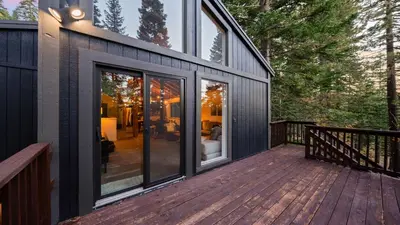 a deck with sliding glass doors on a house at Hot Tub Sauna Forest Views in Tahoe Donner Cedar Summit by Avantstay in Truckee
