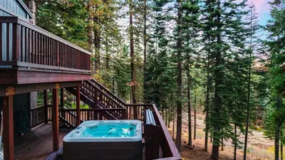 a hot tub on the deck of a house at Hot Tub Sauna Forest Views in Tahoe Donner Cedar Summit by Avantstay in Truckee