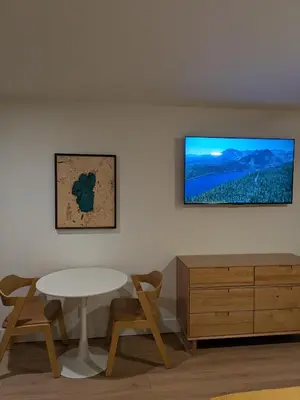 a room with a table and chairs and a tv on a wall at The Iceberg Tahoe in South Lake Tahoe