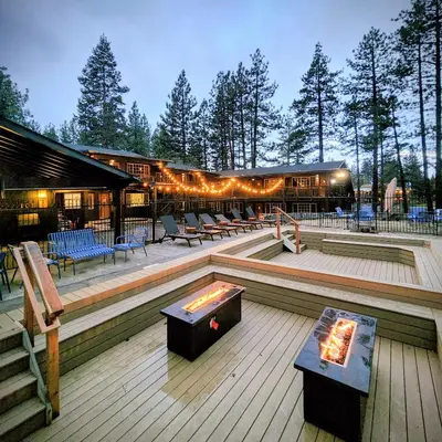 a building with a fire pit on a deck at The Iceberg Tahoe in South Lake Tahoe