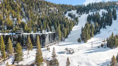 a ski resort in the middle of a snow covered mountain at Remodeled Second Floor Valley View suite in Olympic Valley
