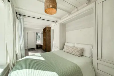 a bedroom with a bed with a green comforter at Panoramic Peaks at Alpine by Tahoe Getaways - Pet Friendly, AC, Hot Tub, Shuttle & Stunning Views in Alpine Meadows